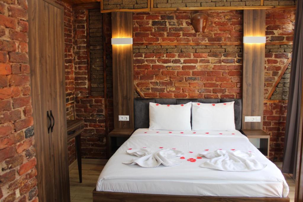 a bedroom with a bed with white towels on it at Han Suite Hotel in Istanbul