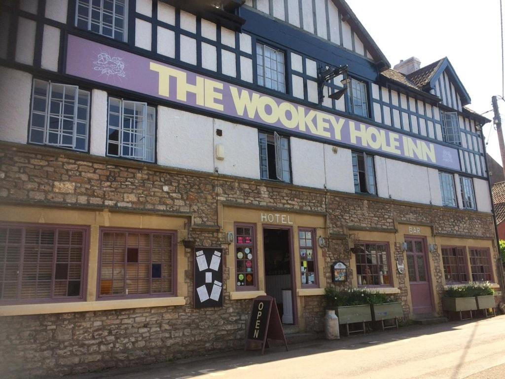 a building with a sign that reads the woodsley hotel at The Wookey Hole Inn in Wells