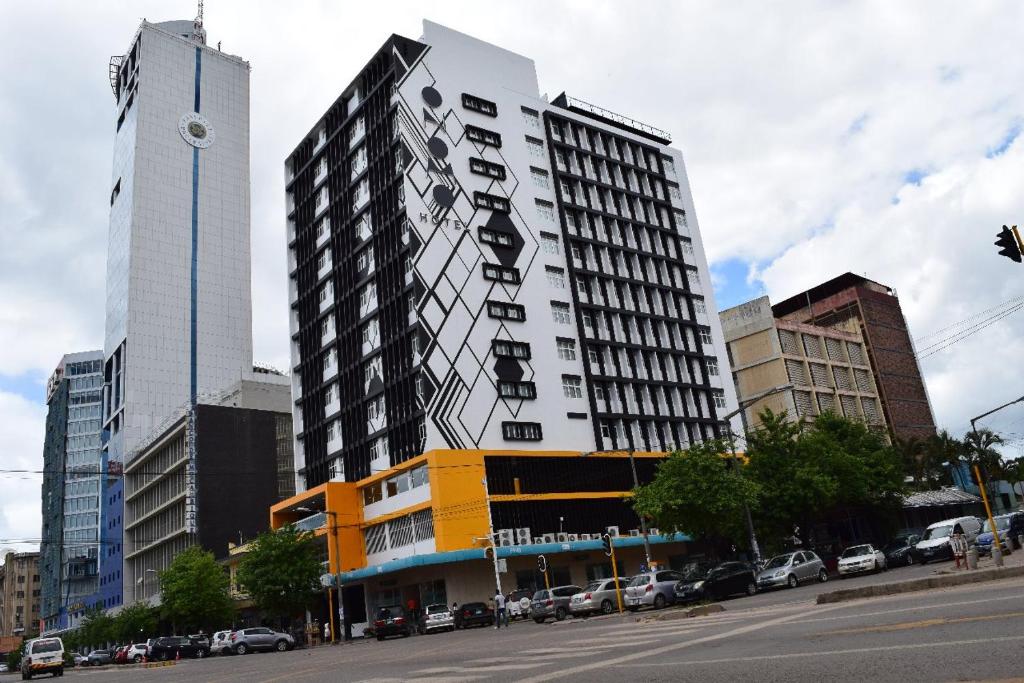 a tall building with a sign on the side of it at ONOMO Hotel Maputo in Maputo