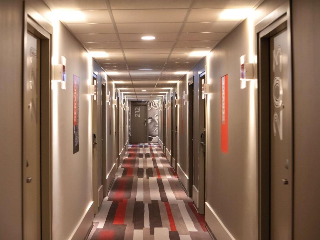 a long hallway with a striped floor in a building at ibis Budapest Castle Hill in Budapest