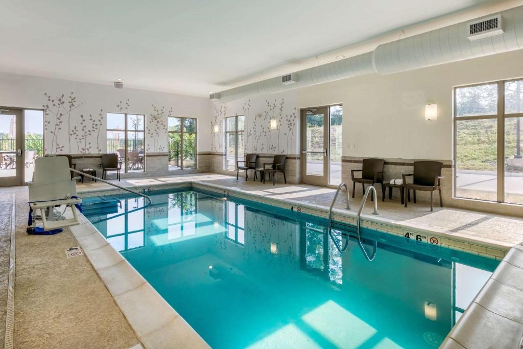 a swimming pool with blue water in a building at Sleep Inn & Suites in Columbia