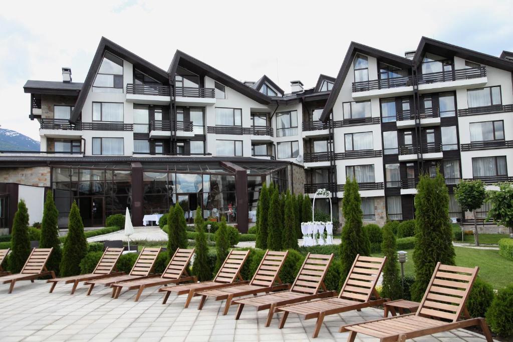a row of chairs in front of a building at ASPEN GOLF RESORT K004 Ski & Spa RELAX APARTMENT in Razlog