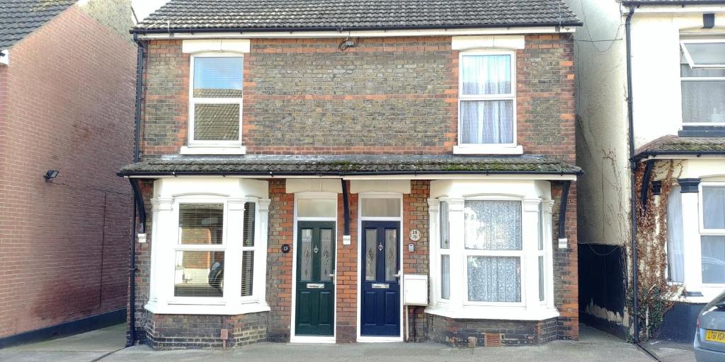 an old brick house with a blue door at Victoria Road, comfortable 3 bedroom houses with fast Wi-Fi in Sittingbourne