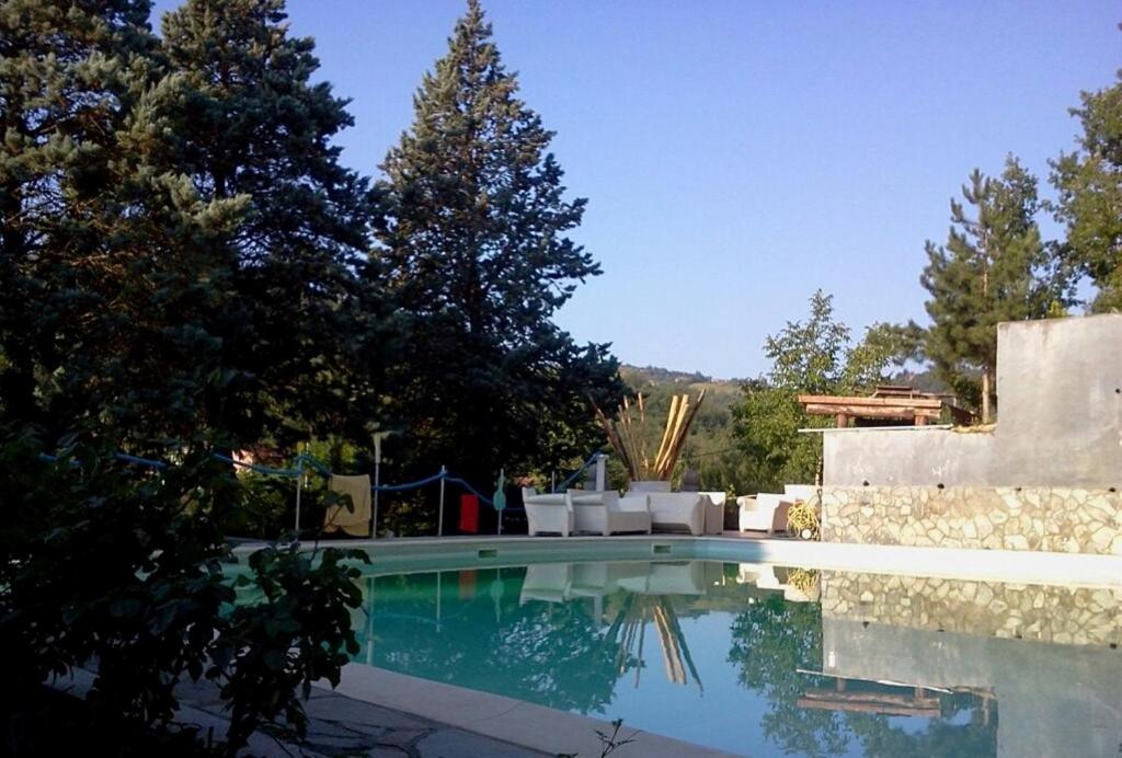 una piscina en un patio con árboles en Villa Gioia, en Acqui Terme
