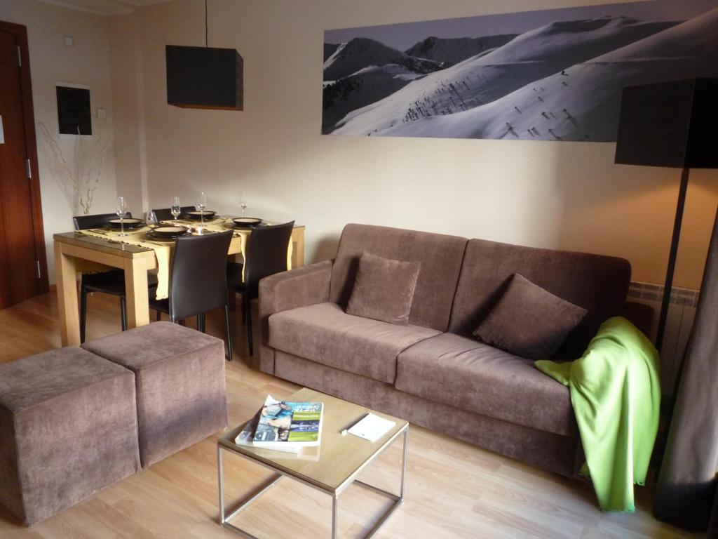 a living room with a couch and a table at Apartamentos Superior El Tarter in El Tarter