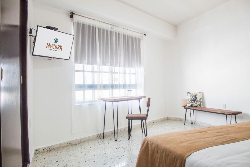 Postel nebo postele na pokoji v ubytování Múcara hotel