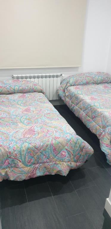 two beds sitting next to each other in a room at ALTOZANO in Albacete