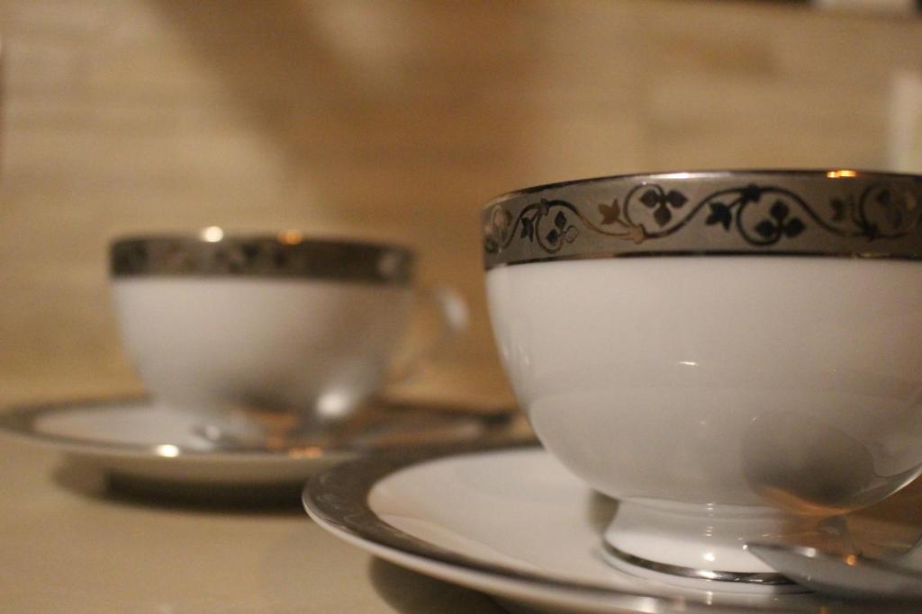 two cups and saucers sitting on a table at Grace in Nuwara Eliya