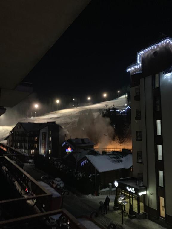 a building with smoke coming out of it at night at 100 metriv vid vytyagu in Bukovel