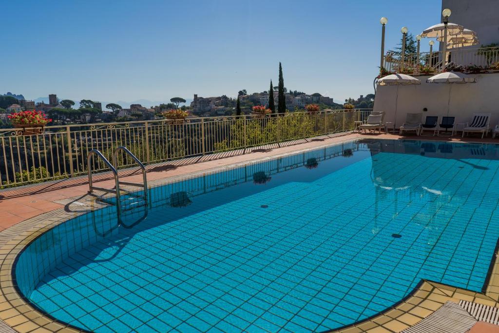 a large swimming pool with blue water at Ravello View in Scala