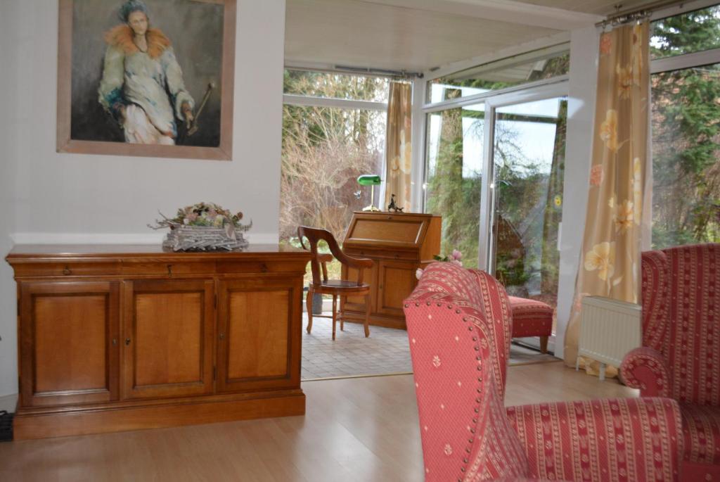 a living room with a painting of a woman and a piano at Ferienwohnung Freiraumwohnung in Tessenow