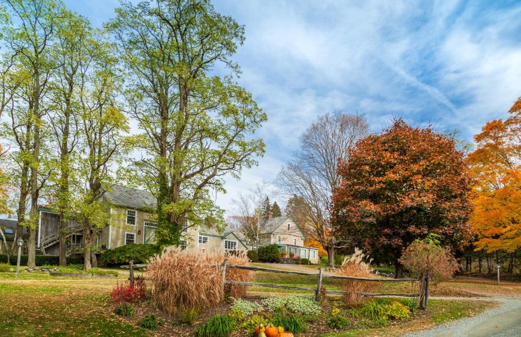 a home in the fall with a fence and trees at Chesterfield Inn in West Chesterfield