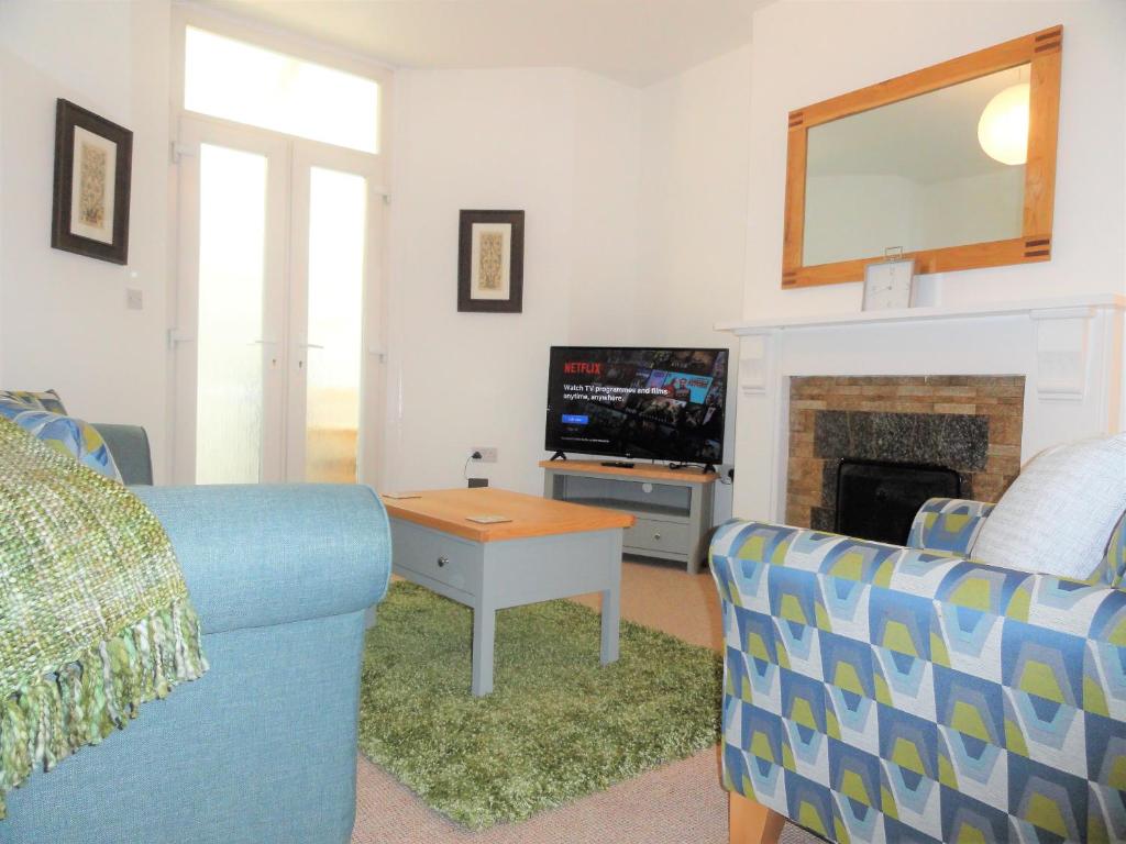 A seating area at Homely and well appointed Priory Apartment by Cliftonvalley Apartments