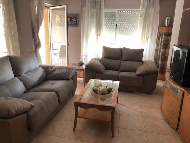 a living room with a couch and a coffee table at Apartamento las Yucas - Aguilas in Águilas