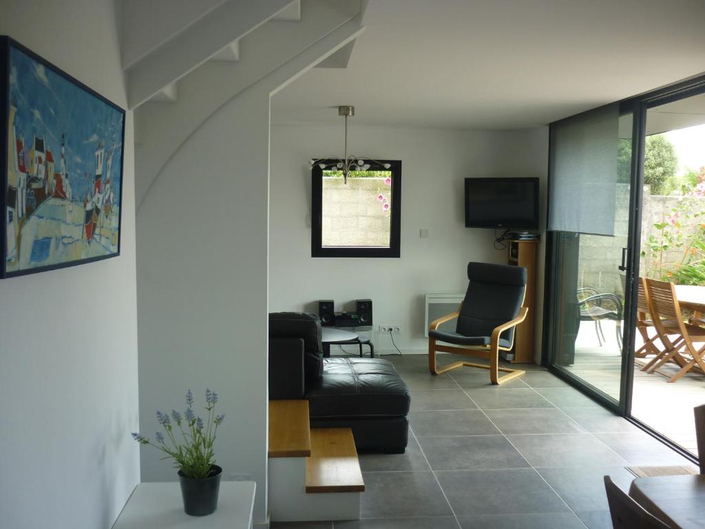 a living room with a couch and a chair at La Maison De La Rade in Le Relecq-Kerhuon