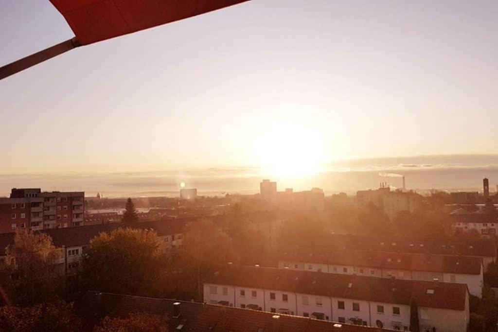 a view of a city with the sun setting at Penthouse "Michelangelo" GreatView, WiFi & Netflix in Schweinfurt