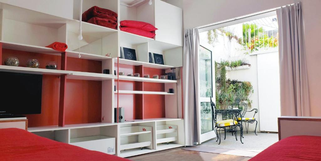 a bedroom with white shelves and a sliding glass door at Dos Patios - Luz, tranquilidad y verde in La Plata