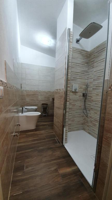 łazienka z prysznicem, wanną i umywalką w obiekcie DOMU NOSTA di Giulio & Ignazia Room1 w mieście Santa Luria