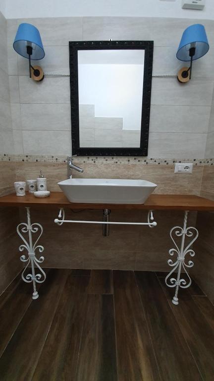 łazienka z umywalką i lustrem w obiekcie DOMU NOSTA di Giulio & Ignazia Room1 w mieście Santa Luria