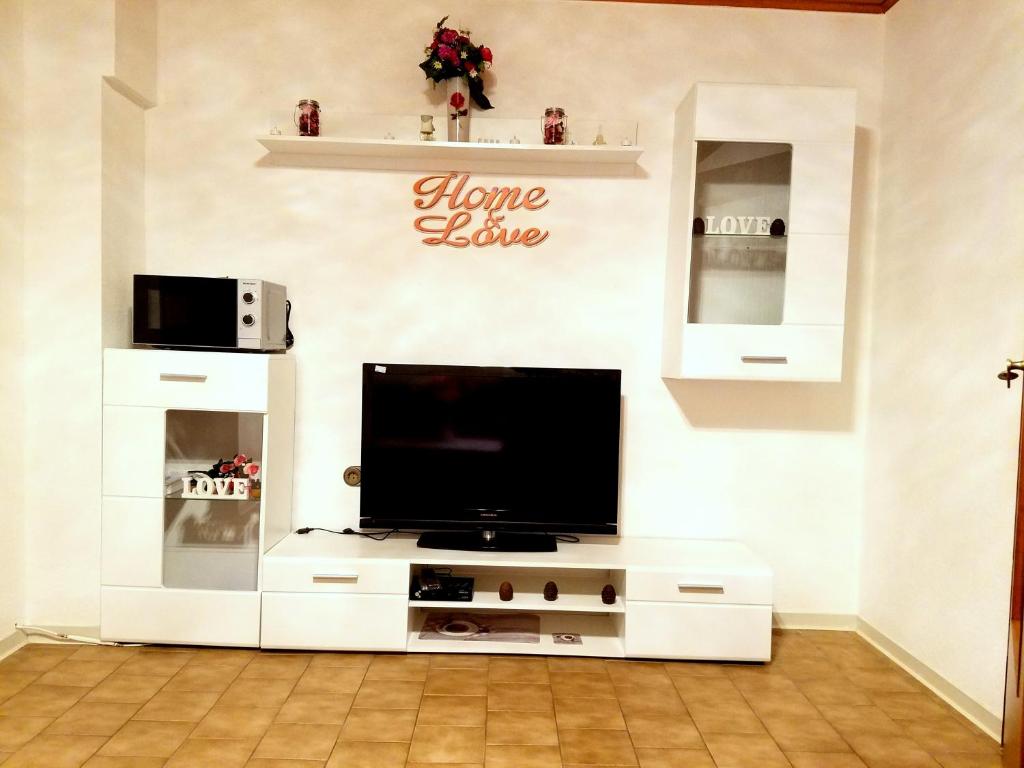 a living room with a tv on a white entertainment center at Ferienwohnung in Friedberg (Hessen) für 1 bis 4 Personen in Friedberg