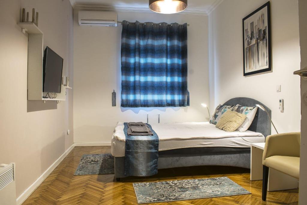 a small room with a bed and a window at Lux Apartment in Belgrade 2 in Belgrade