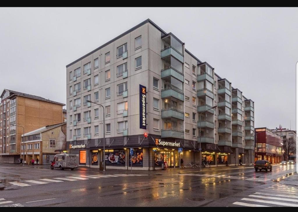 a large building on a city street in the rain at Apartment in City - Antinkatu in Pori