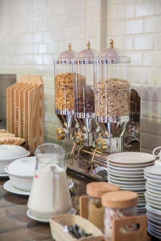 a kitchen counter with a container of food and plates at Kokotel Khao Lak Lighthouse in Khao Lak