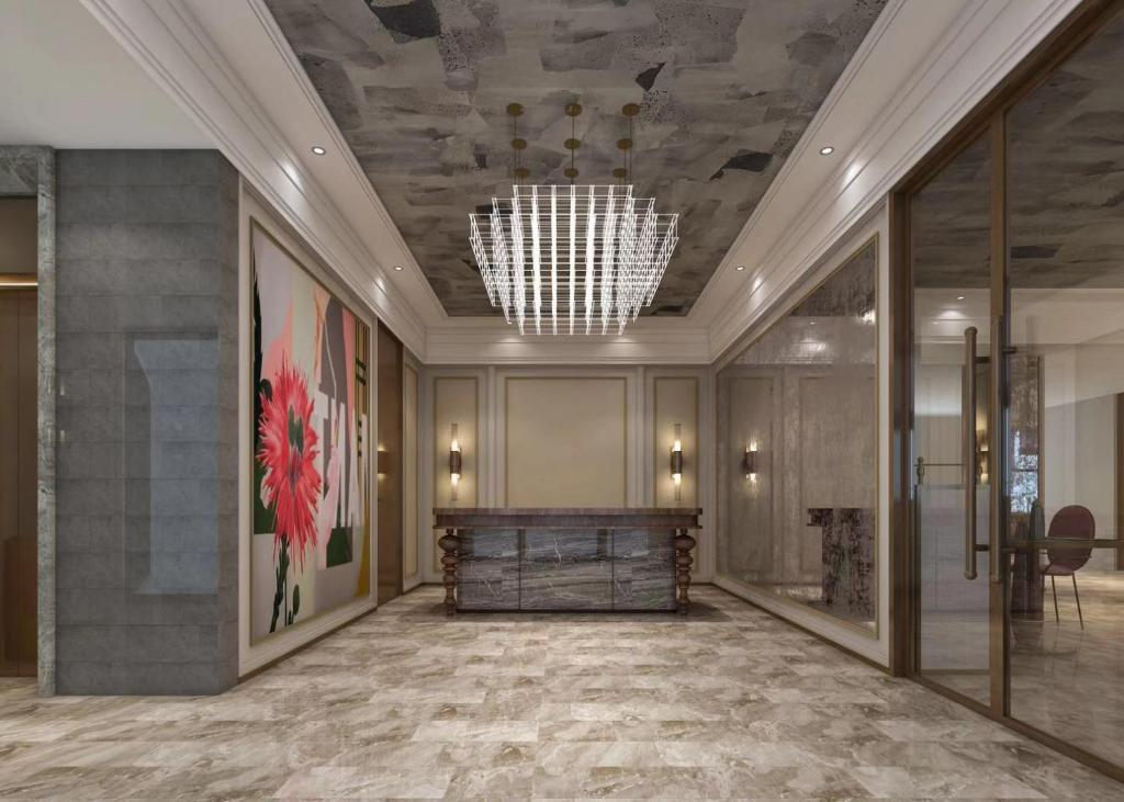 a lobby with a chandelier and a large room at Mercure Shenzhen Futian in Shenzhen