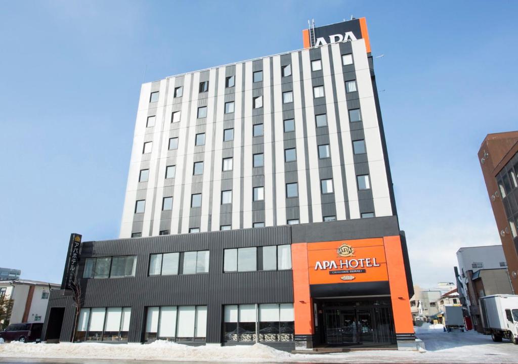 a large building with an am hotel sign on it at APA Hotel Hakodate Ekimae in Hakodate