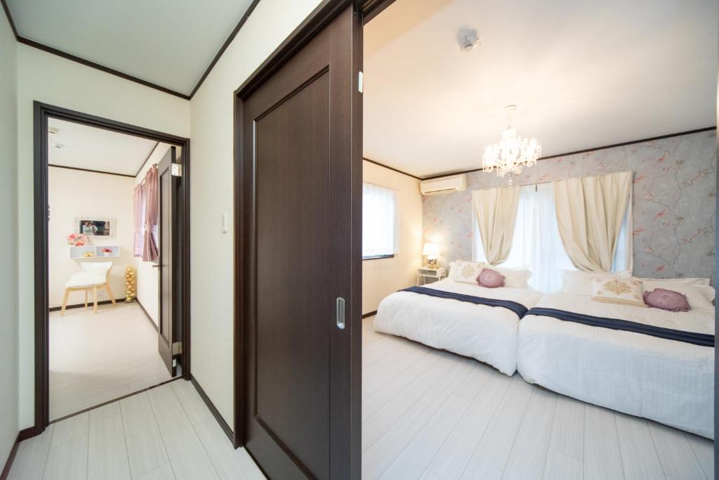 a bedroom with a large bed and a large window at Awaji Central Inn Kuruma713 in Awaji