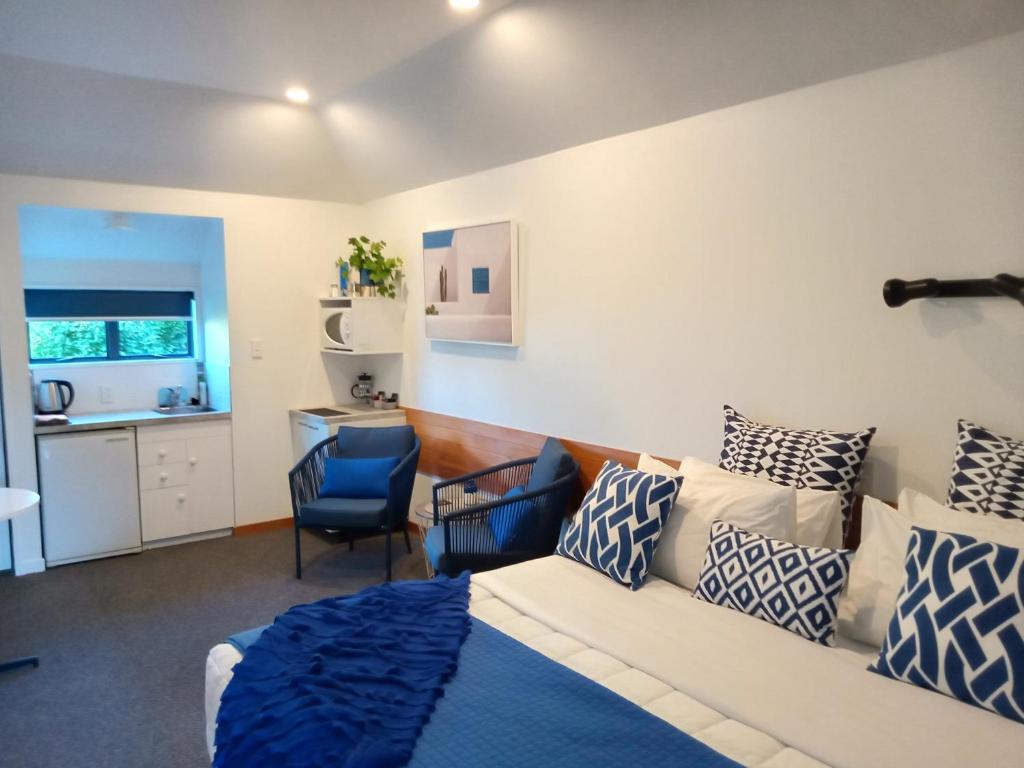 a living room with a bed and a couch at Four Peaks Motel in Geraldine