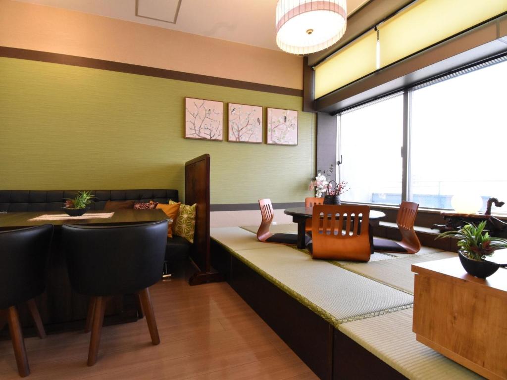 a restaurant with a bench with a table and chairs at Alphabed TakamatsuHyogomachi 603 / Vacation STAY 21889 in Takamatsu