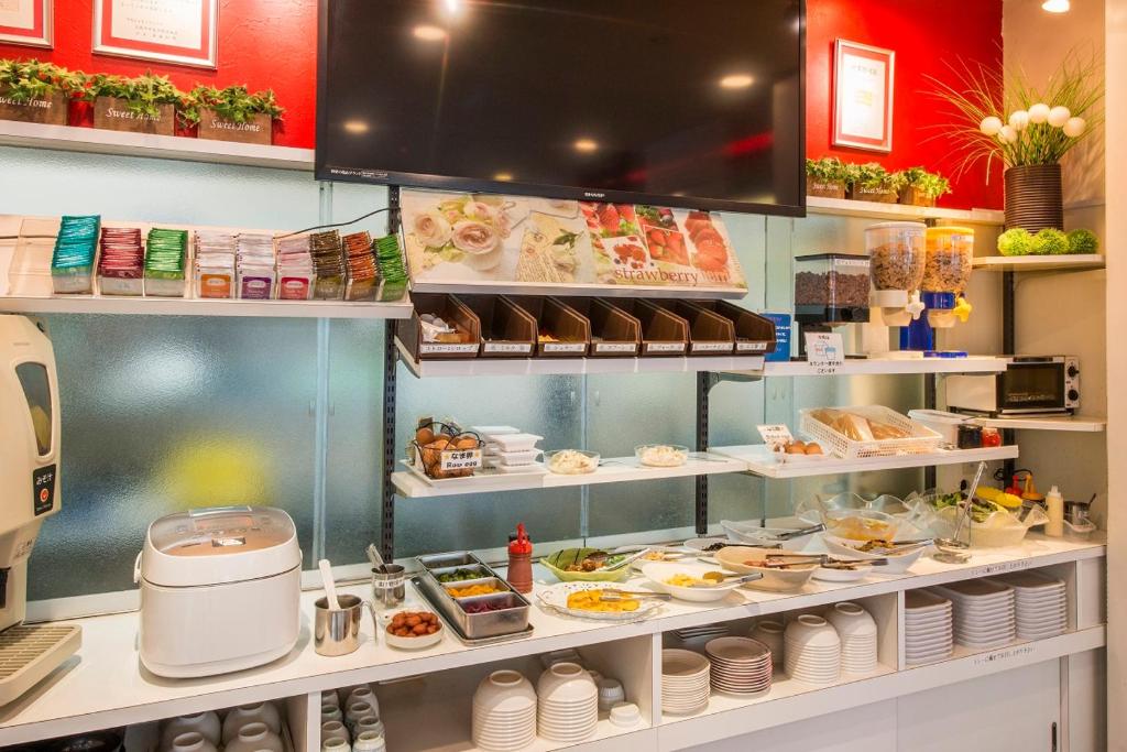 a kitchen with a buffet of food on display at Sejour Inn Nagarekawa in Hiroshima