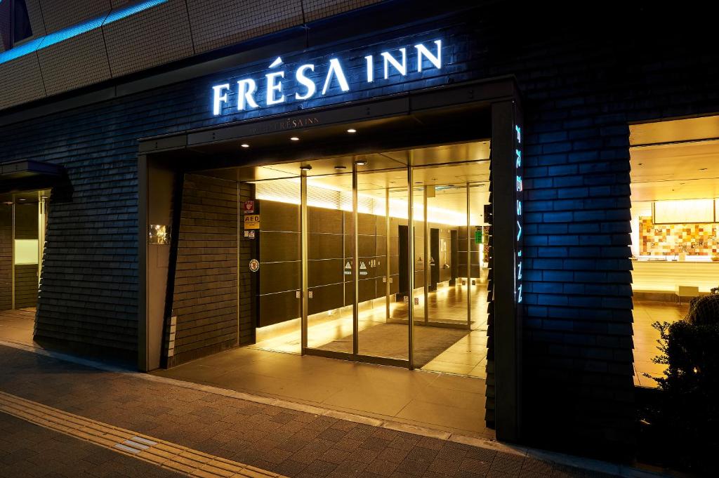 a front door of a store with a sign on it at Sotetsu Fresa Inn Higashi Shinjuku in Tokyo