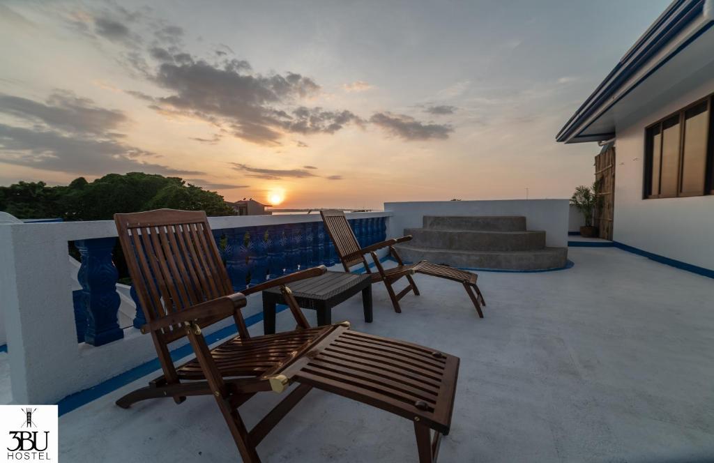 two chairs sitting on the roof of a house at 3BU Hostel La Union in San Fernando