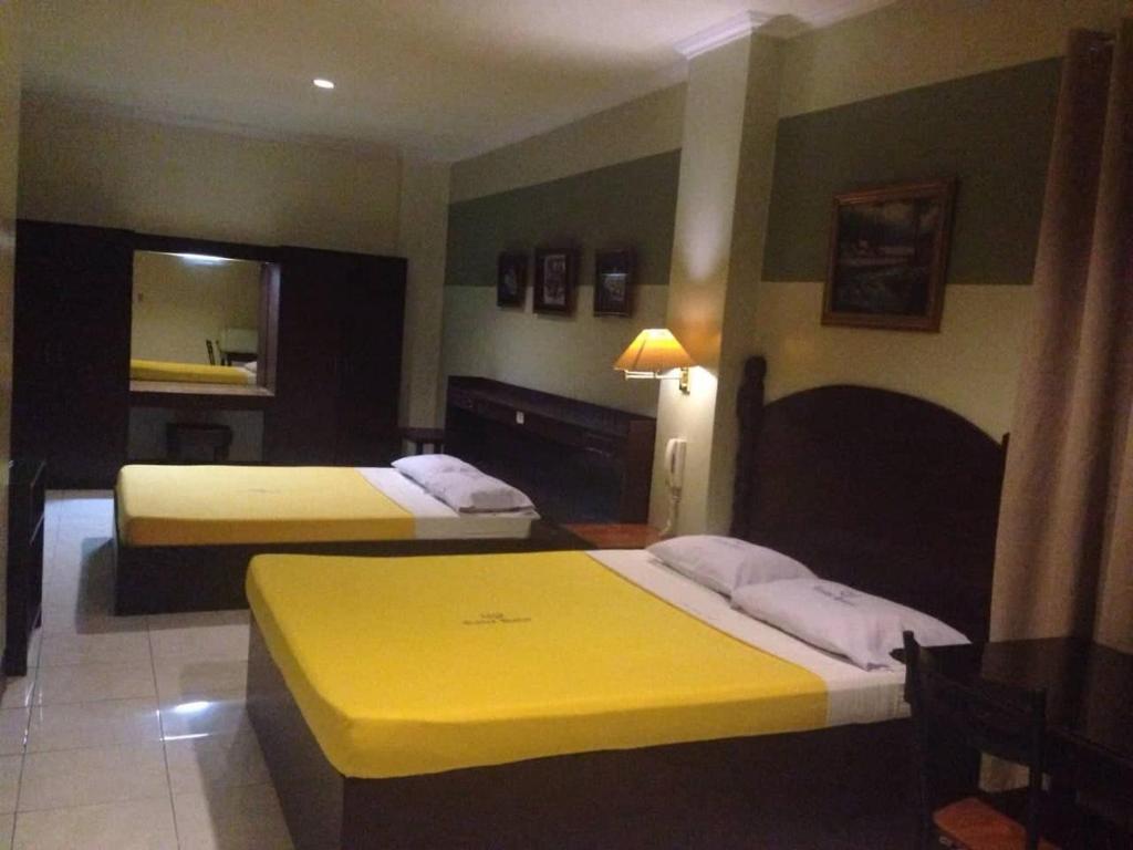 Postel nebo postele na pokoji v ubytování ROLET HOTEL