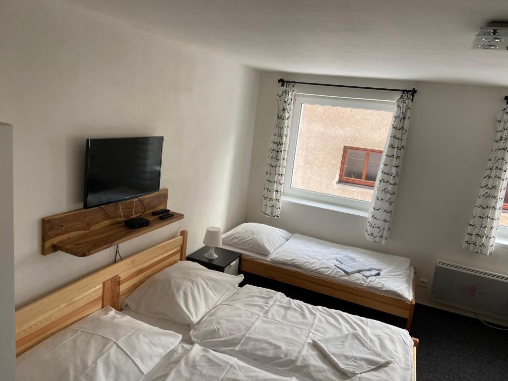 Postel nebo postele na pokoji v ubytování Apartmány Viktorka