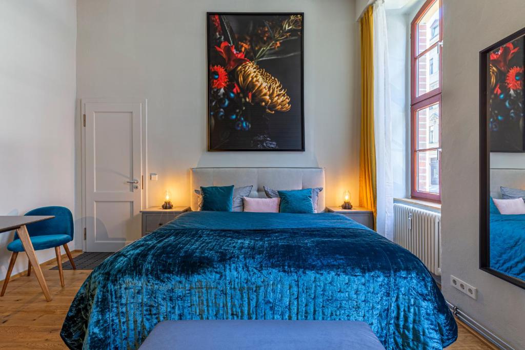 a bedroom with a blue bed with a blue blanket at Loft Apartment Aqua in Leipzig