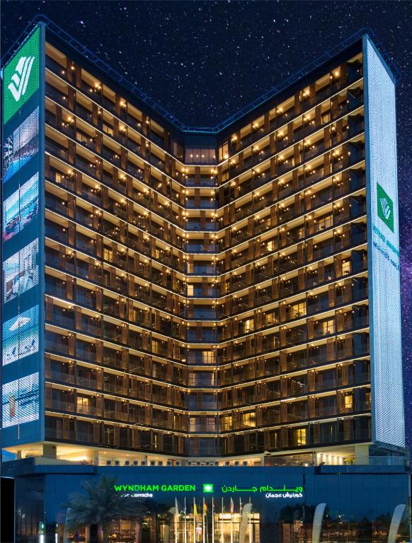 a rendering of the magellan casino hotel at night at Wyndham Garden Ajman Corniche in Ajman 