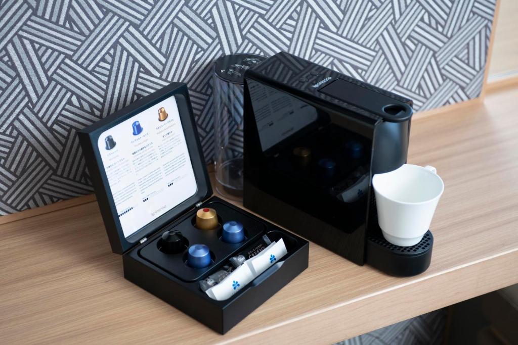 a black box with a tablet on a table at Hotel Nikko Kumamoto in Kumamoto