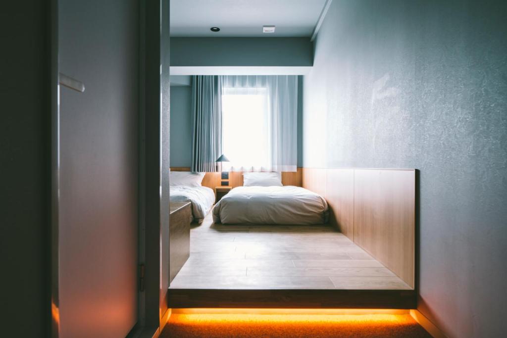 Postel nebo postele na pokoji v ubytování LANDABOUT TOKYO
