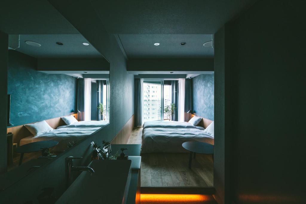 Postel nebo postele na pokoji v ubytování LANDABOUT TOKYO