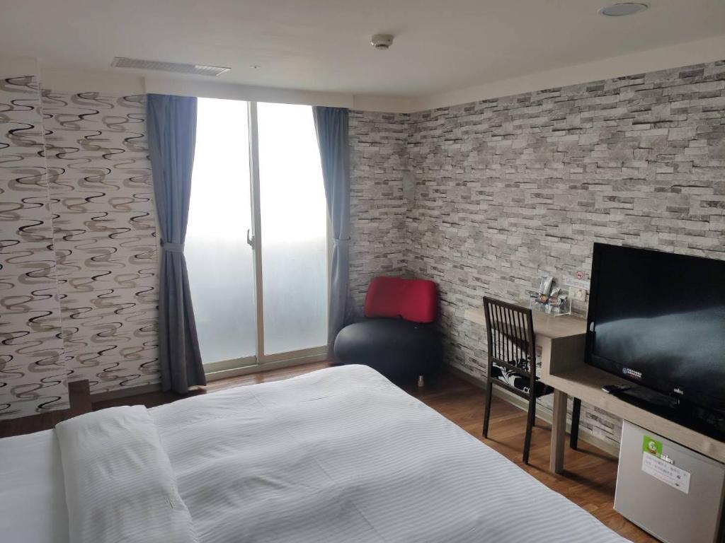 Postel nebo postele na pokoji v ubytování HengChang Business Hotel