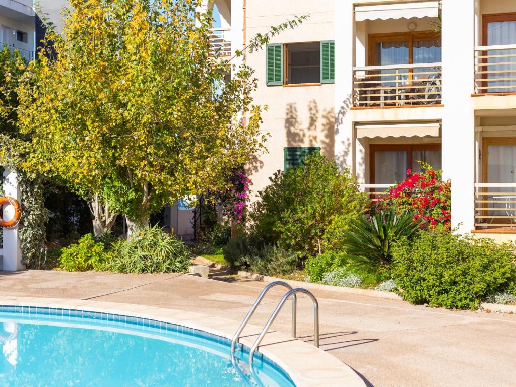 a swimming pool in front of a building at Voramar 2h in Port de Pollensa