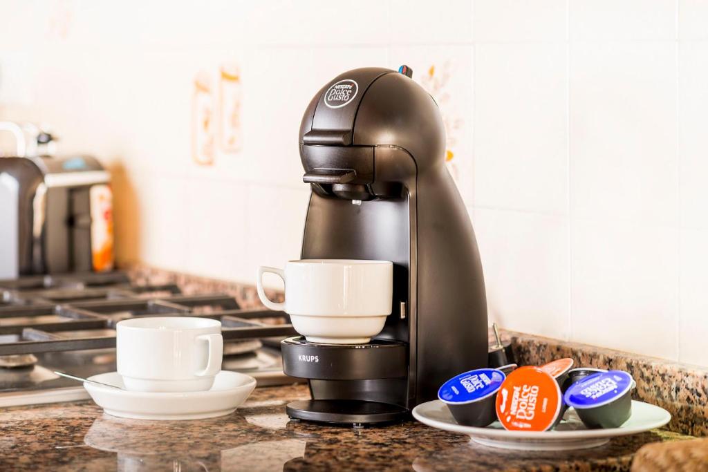 a coffee maker sitting on top of a counter at Apartaments Els Llorers in Lloret de Mar