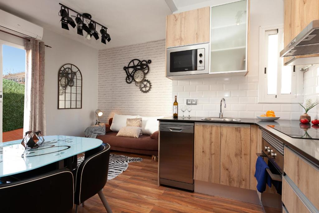 a kitchen and living room with a couch at Sunny Penthouse in Sagrada Familia in Barcelona