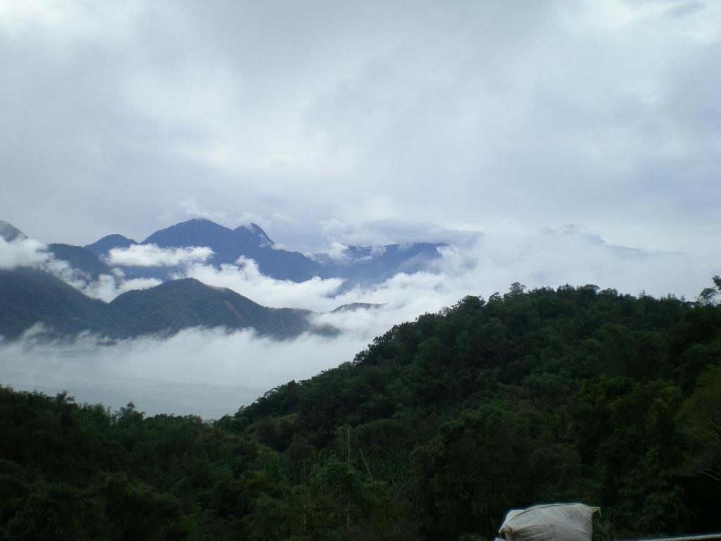 a view of a mountain with clouds in the valley at Zen and Pine Resort in Shuili