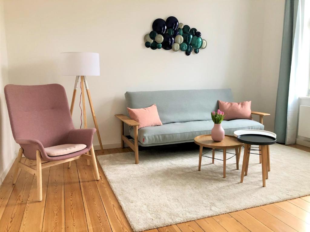 a living room with a couch and two chairs at Ferienapartment Warnemünde 2 in Warnemünde