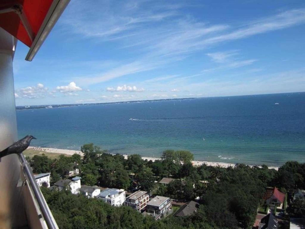a view of the beach and the ocean from a balcony at Seeblick Apartment in Plaza Maritim Residenz in Timmendorfer Strand
