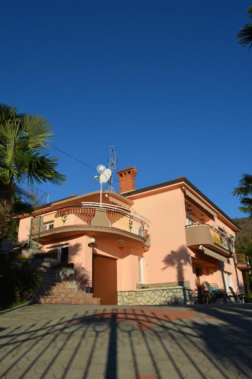 a house with a balcony on the side of it at Apartment Valentina in Opatija